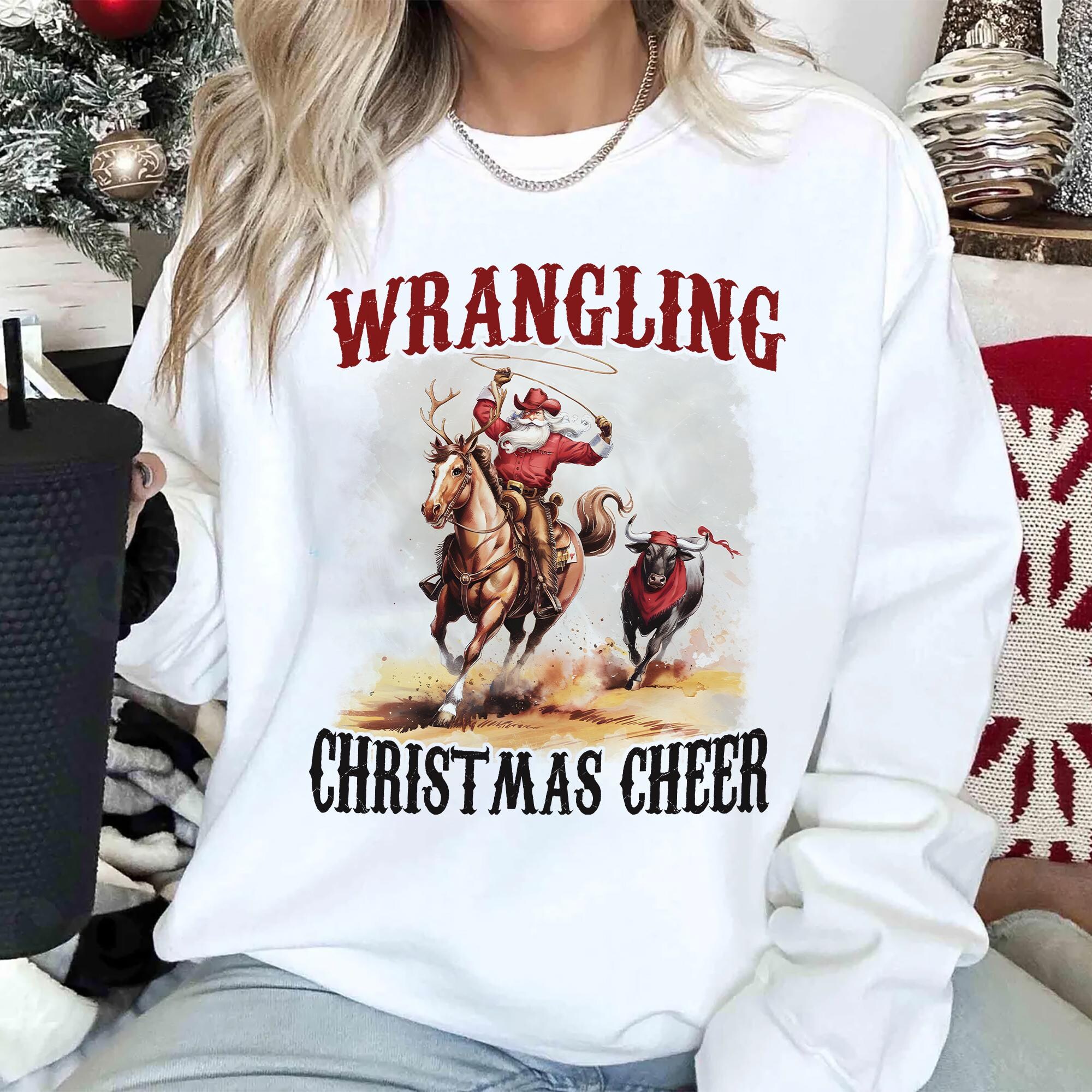 il_2000xN.7315246395_cqnx.jpg Wrangling Christmas Cheer Sweatshirt, estern Christmas Shirt, Cowboy Santa Shirt,Funny Christmas Shirt,Holiday Christmas Sweatshirt,Xmas Tee
